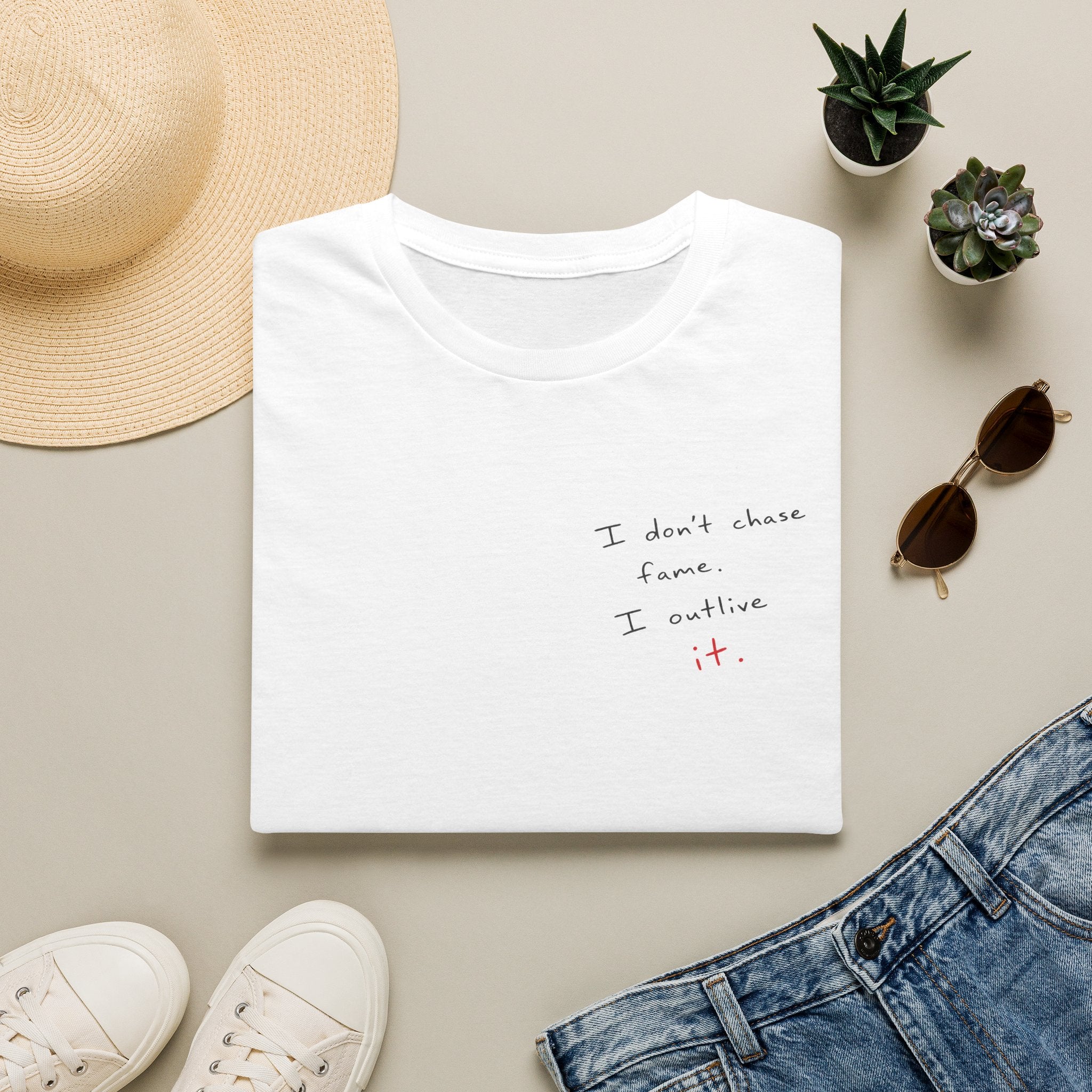 Minimalist White T‑Shirt - "I don't chase fame I cultivate it." Small Script Chest Print